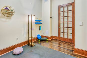 A room with a wooden floor and a door with a window.